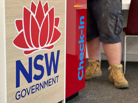 Unrecognizable People Waiting in Line at Service NSW Government Centre