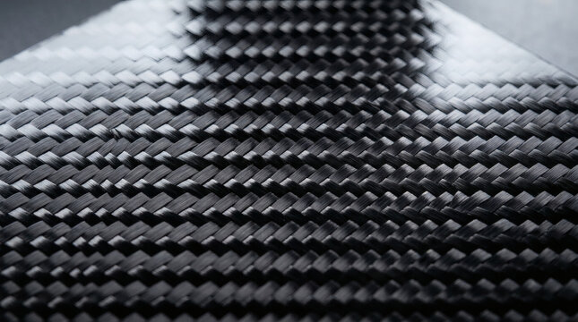  High tech classic twill carbon fiber weave material texture macro close up with glossy protective clear coat resin reflection abstract engineering automotive racing background copy space