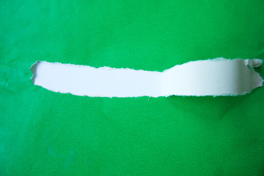 A white paper layer revealed beneath a torn green sheet. A torn paper section with a white background area for text. The torn green paper layer peels back, exposing the white layer underneath.
