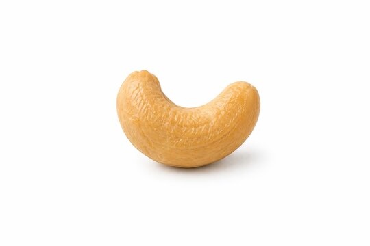 A single roasted cashew nut on a white background