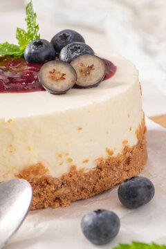 Mini cheesecake with blueberry topping and mint leaves close up
