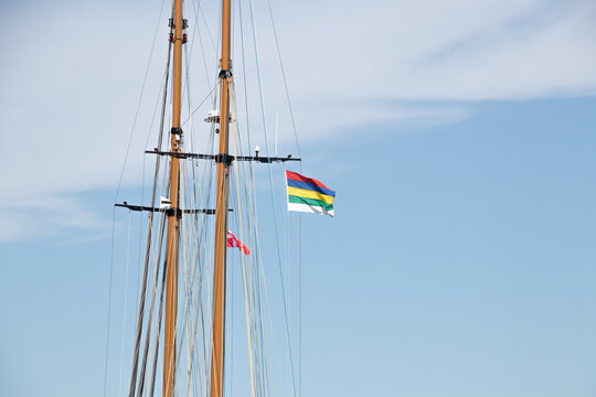 Sailboat Mast with Colorful Maritime Flags Against Blue Sky in Copenhagen Harbor