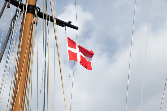 Danish Flag Flying from Traditional Sailboat Mast in Copenhagen Harbor, Denmark