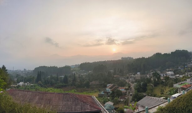 Scenic Mountain Village Landscape at Sunrise with Misty Sky and Green Trees at Cisarua, Bogor, Indonesia.
