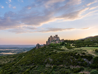 Fototapeta premium Medieval Loarre Castle beneath dramatic sunset clouds in Spain