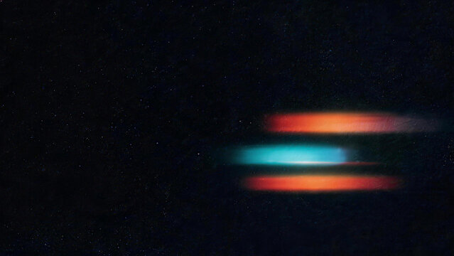 Layered cyan red and orange horizontal light streak overlay on dark film background