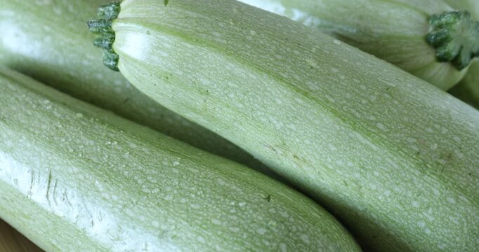 Pile of fresh zucchinis as background, closeup