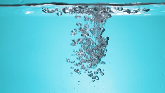 water drop splash isolated. splashing water with transparent droplets, waves. Fresh, clean, pure liquid, cool beverage. Abstract blue background, macro shot. Nature, healthy drink. Beauty.