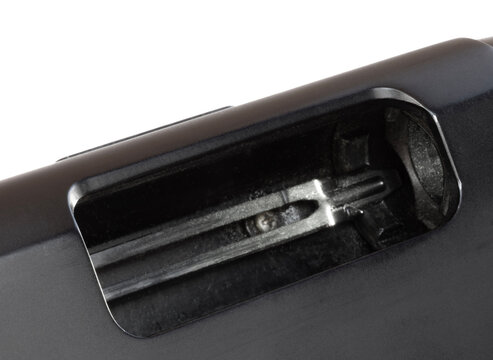 Action open on a shotgun showing no ammo in the chamber