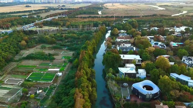 Aerial Flyover Along Tree-Lined Canal Near Sheshan Mountain