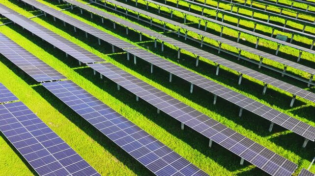 Low drone flight along rows of solar panels