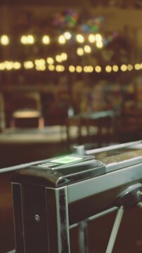 A sleek ticket scanner stands ready at the entrance, illuminated gently. Lively lights dance in the background, hinting at the joy and excitement of the fair waiting beyond.