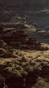 A breathtaking view reveals towering rock formations in warm golden light. The rugged textures and intricate patterns create a serene atmosphere, inviting exploration and wonder.