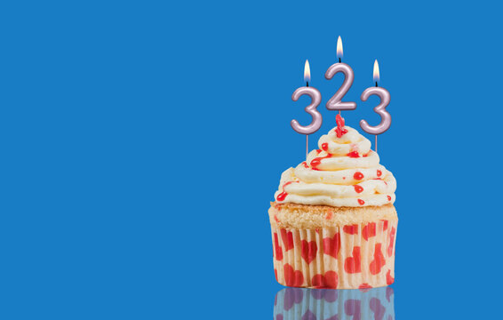 Birthday Or Anniversary Cupcake With Lit Candles; Candles Forming The Number 323