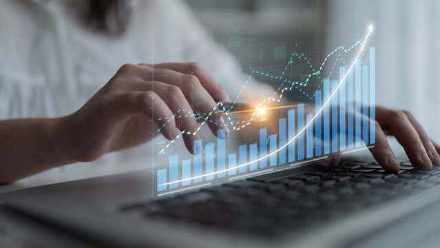 Business professional analyzes financial data using a laptop. Digital graphs showcase trends and growth, emphasizing the importance of informed decision-making in business strategy. Impute