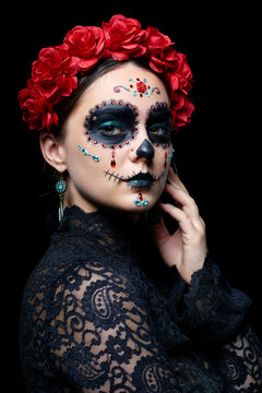 Halloween beauty portrait of woman. Beautiful female face adorned with Santa Muerte makeup.