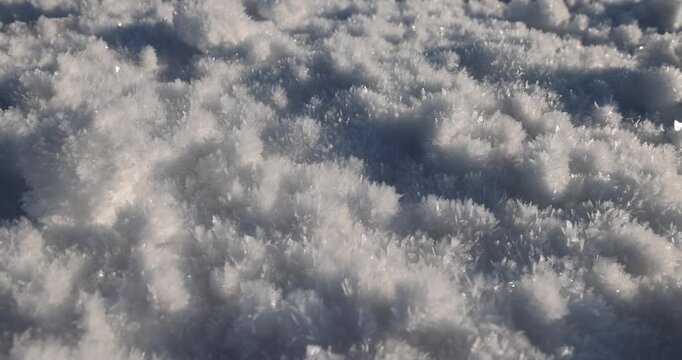   Ice crystals of white snow, fluffy frost close-up outdoors in the frosty winter season
