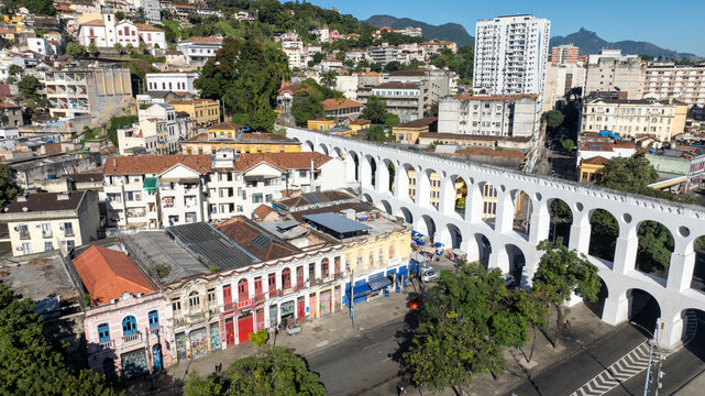 Arcos da Lapa featuring its iconic white arches stretching across the urban landscape with surrounding buildings and clear sky in Rio de Janeiro, Rio de Janeiro, Brazil. Aerial view.