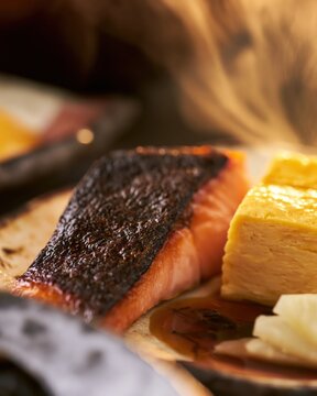 Close up of grilled salmon Japanese breakfast dish with rising steam