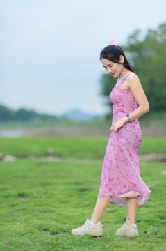 Young Woman in Pink Dress Strolling by Sai Thong Reservoir, Thailand