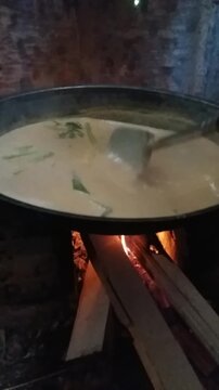Traditional Rendang Preparation with Coconut Milk on Wood Fire