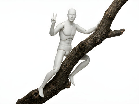 Articulated white mannequin figure climbing a natural brown tree branch against a plain white background, plastic artist model posing with a peace sign gesture on a textured wood limb.