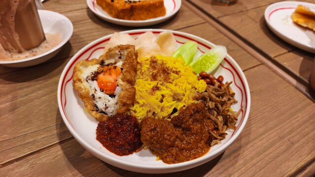 Jakarta, Indonesia - July 21, 2026: Delicious nasi lemak with beef rendang traditional meal served on a plate