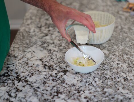 Man suffering severe stomach pain and cramps after eating shredded iceberg lettuce contaminated foodborne illness, illustrating salad recall symptoms