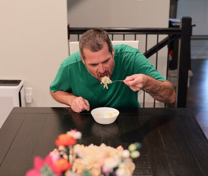 Man suffering severe stomach pain and cramps after eating shredded iceberg lettuce contaminated foodborne illness, illustrating salad recall symptoms