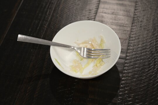 Man suffering severe stomach pain and cramps after eating shredded iceberg lettuce contaminated foodborne illness, illustrating salad recall symptoms