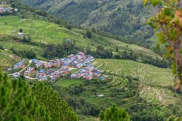 Fotobehang Groen Aerial view of Jilu village nestled among terraced hills, Nepal  © ThamiShankar