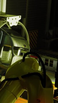 In a futuristic manufacturing space, robotic arms work diligently under dim lighting, creating intricate products. A blend of technology and precision is evident in this innovative environment.