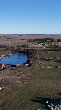 Aerial View of Rural Australian Landscape with Dam and Granite Rocks