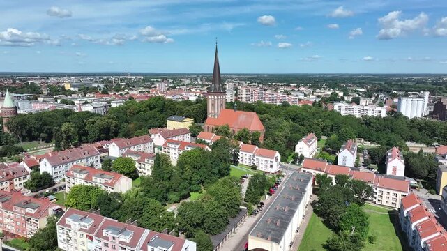 Stargard rural city church apartments park Poland. Northern Poland in 8th century. Historical stronghold, defensive walls, gates towers. WW II POW camp controlled by Germany. Brick church.
