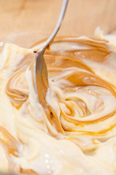 Cooking cream. Preparing dessert. Spoon stirring soft butter caramel in bowl mixing tasty condensed milk ingredient recipe pastry.