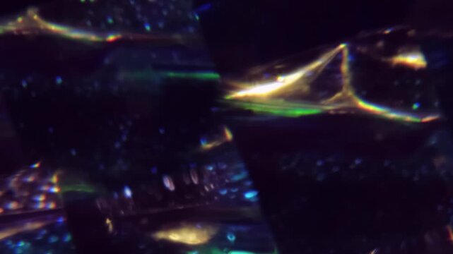 Defocused dazzle glow. Illuminated ray. Yellow green blue color optical visual glitter gleam leaking on abstract creative dark black background.