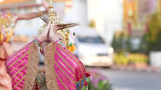 Traditional Thai Dancer Performing in Ornate Gold Headdress and Costume