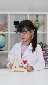 Young Girl in Lab Coat Giving High Five During Science Experiment