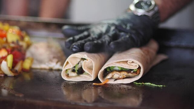 Cooking wraps with fresh ingredients at a street market