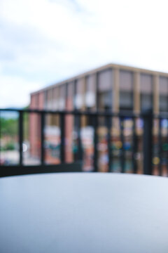 Vertical of a table top with blurred fence and modern building in background