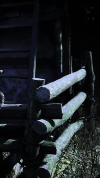 A weathered wooden fence stands tall in a quiet setting, illuminated by soft twilight. The scene conveys a sense of peace, inviting calm reflection under the fading light.