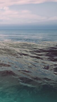 Waves gently ripple across the surface as the sun sets, painting the sky with soft colors. Peaceful waters create a serene atmosphere, inviting deep reflection and tranquility.