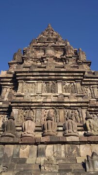 Frontal close view showcases the carved entrance, symmetrical facade, and ornate crown of a historic Prambanan Temple shrine.