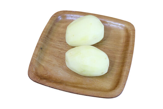 Fresh peeled raw potatoes on wooden plate isolated on transparent background photo