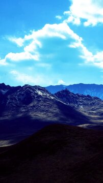 Shadows dance on rugged peaks as the sun begins to set. The sky is painted in shades of blue, reflecting the calmness of nature. An enchanting view evokes a sense of peace.