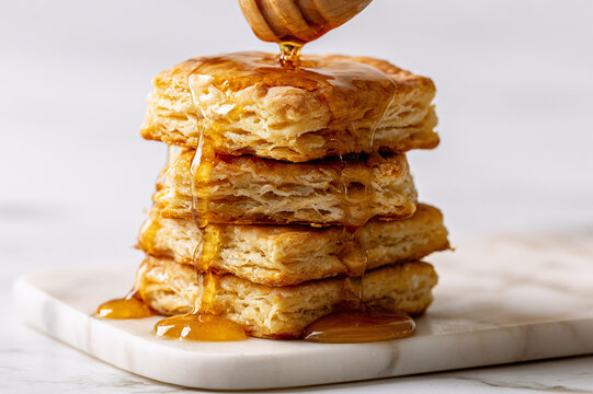 square-cut biscuit stack drenched in dripping amber honey