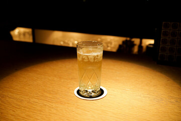 Cocktail glass on wooden bar counter under spotlight © 勇亮 吉田