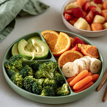 Healthy finger foods encouraging baby-led weaning with fresh vegetables and fruits for growing infants.