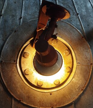Industrial reactor sight glass lamp illuminating stainless steel tank for process monitoring