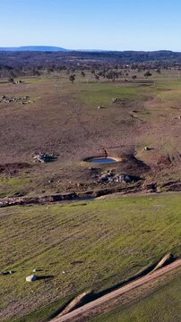 Aerial View of Rural Dirt Road and Granite Boulders in Uralla